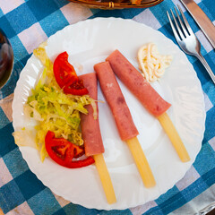 Sticker - Deliciously asparagus rolls with ham and salad from vegetables on plate