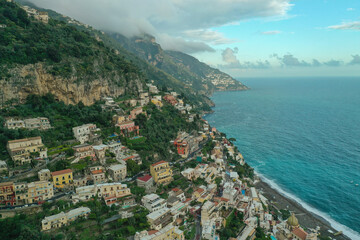 Wall Mural - Aerial view of buildings along the mountains and ocean at the beautiful Amalfi Coast in Italy