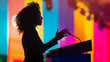 © Gary - Silhouette of a young African American woman speaking at a podium with her hand raised, colorful background