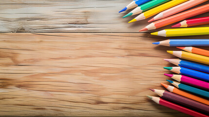 Wall Mural - Colorful pencils on wooden background with copy space for creative design