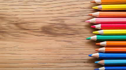 Wall Mural - Colorful pencils on wooden background with copy space for creative design