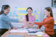 © ArLawKa - Brainstorming of a team of young Asian women, Asian creative teamwork group in a new business meeting to develop a project with...