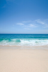 a picturesque view of the beach in cabo san lucas, mexico, with clear turquoise waves gently crashin
