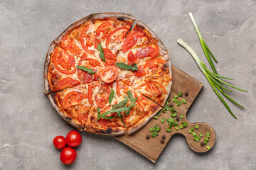 Wall Mural - Wooden board with tasty pizza, green onion and tomatoes on grey background