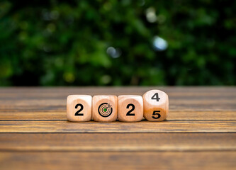 Poster - Happy new year 2025 with green business goal, Environmental sustainability concepts. Flipping 2024 to 2025 numbers with target bullseye icon on wooden cube blocks on wood table, nature background.