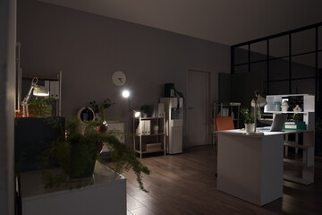 Sticker - Interior of dark office with desks, shelf units and glowing lamps