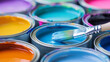 © Mehran - Colorful paintbrushes rest on open cans of paint.