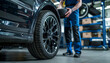 © Oleksiy - Male mechanic with car tire in auto store