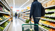 © Temteen - Man pushing full shopping cart through crowded supermarket aisle