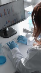 Aufkleber - In a laboratory, a scientist conducts research using a computer and a microscope in areas of biology, biotechnology, and chemistry, contributing to advancements in healthcare and pharmaceuticals