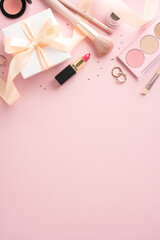 Wall Mural - Top vertical view of various makeup products and a gift box with ribbon on a pink background