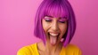 © Nataliia_Trushchenko - A woman with purple hair and purple lipstick is smiling and sticking out her tongue. The image conveys a fun and playful mood, as the woman's tongue sticking out and her bright purple hair