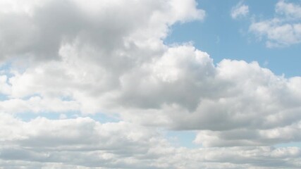 Wall Mural - Huge, low clouds slowly move across the sky. Cumulus white clouds with dark bottoms.