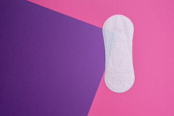 Wall Mural - Women's pads and tampon. Sanitary pads lie next to a tampon on an isolated background on a pink and white background. The concept of health, feminine hygiene and the menstrual cycle 