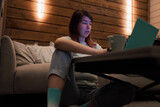 Fototapeta Konie - Woman Typing on Laptop with Coffee Cup in Cozy Room