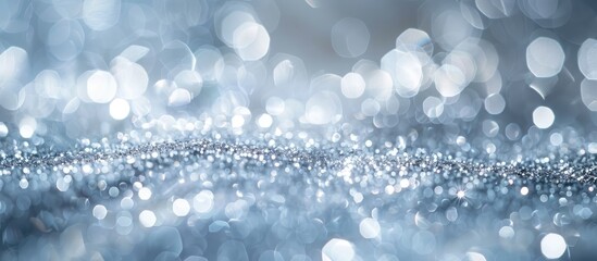 Poster - Pale silver blue glitter light background with beautiful bokeh creates an abstract composition focusing on shallow depth of field with a copy space image