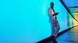 © VISTA by Westend61 - Fashionable businessman leaning on glowing blue wall