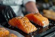 © Igor - close up salmon fillet of chef woman in uniform in kitchen in luxury restaurant