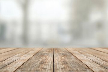 Poster - Empty wooden tabletop showing perspective with blurred background