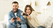 © Prostock-studio - Fans Of Xbox. Crazy Couple Enjoying Playing Videogame On Playstation, Resting At Home