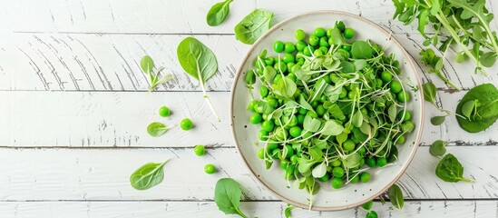 Poster - Top view of a vegetarian green pea salad with microgreens and vegetables on a white wooden surface perfect for showcasing vegan food with available copy space for images or text