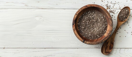 Poster - Top view of a wooden bowl with chia seeds and a spoon on a white wooden surface providing copy space image