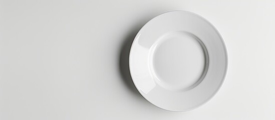 Poster - Isolated white ceramic plate with copy space image on a white background and clipping path