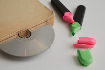 Aufkleber - Old book and compact disc between pages next to colored markers, compact disc as a bookmark in a book, electronic library, archive recordings
