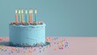 © DailyStock - Beautiful Blue Birthday Cake With Lit Candles on Table Celebrating a Special Moment