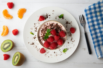 Wall Mural - Delicious raspberry mousse with red berries from an overhead perspective.