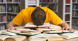 © Prostock-studio - Student studying hard exam and sleeping on books in library, free space
