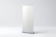 © kansak01 - Empty white roll-up banner mockup standing upright on a clean white background, perfect for displaying promotional messages or company branding.