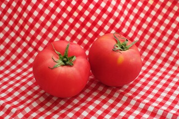 Wall Mural - Fresh tomatoes on the red cloth