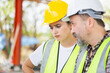 © JU.STOCKER - Engineer team in hardhats discussing on construction site