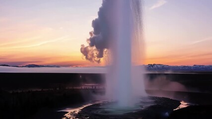 Sticker - The breathtaking sight of a geyser bursting to life backdropped by the vibrant colors of the dawn sky.