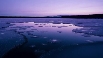 Wall Mural - The peacefulness of a frozen lake at twilight with no signs of movement or life except for the occasional gust of wind.