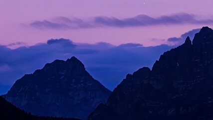 Poster - As the light fades the mountains take on a mysterious beauty their jagged edges blending with the fading sky in a magical display of colors.