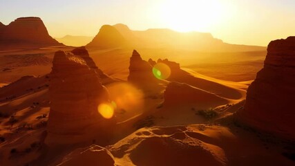Poster - A stunning golden hour shot of a rocky desert at sunrise with the jagged peaks and boulders bathed in warm light.