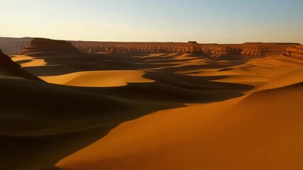 Poster - Breathtaking views of the desert cliffs surrounded by endless stretches of sand.