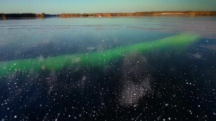Poster - A starry night sky reflecting on the glistening frozen lake as if millions of diamonds were tered on its surface.