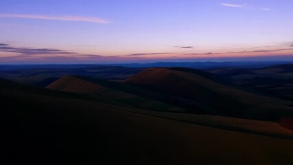 Poster - A tranquil journey through rolling hills illuminated by the soft dusky light of twilight.