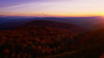 Poster - A cinematic aerial view of the autumn hills at twilight with the fading light casting a dreamy ethereal glow.