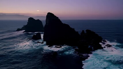 Poster - Showing the wild and unforgiving nature of the rocky islands at dusk as the fading light creates dramatic shadows and silhouettes.
