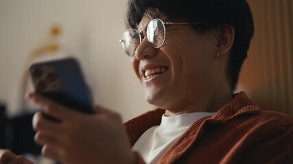 surprised asian man reading message with great news on phone, winning a lottery