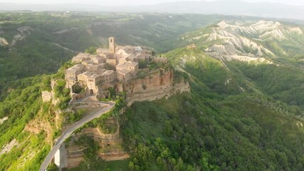 Wall Mural - Aerial summer evening view of famous Civita di Bagnoregio town, beautiful place located on top of a volcanic tuff hill overlooking the Tiber river valley. The place has Etruscan and Medieval origins.