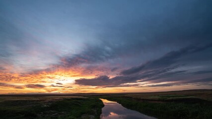 Wall Mural - beautiful colorful sunset over the river, red and yellow flashes. ripples on water surface of sea or