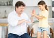 © caftor - Father and little daughter playing rock paper scissors game