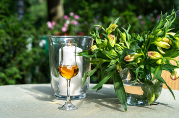 Amaretto almond liquor, sweet alcohol drink, brown Italian liquor made from apricot kernels, on summer table