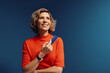 © Jacob Lund - Mature woman holding a credit card in a vibrant, monochromatic setting with bold colors