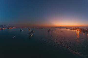 Panoramic view of a cargo ship from high up in the middle of the river with beautiful evening light.